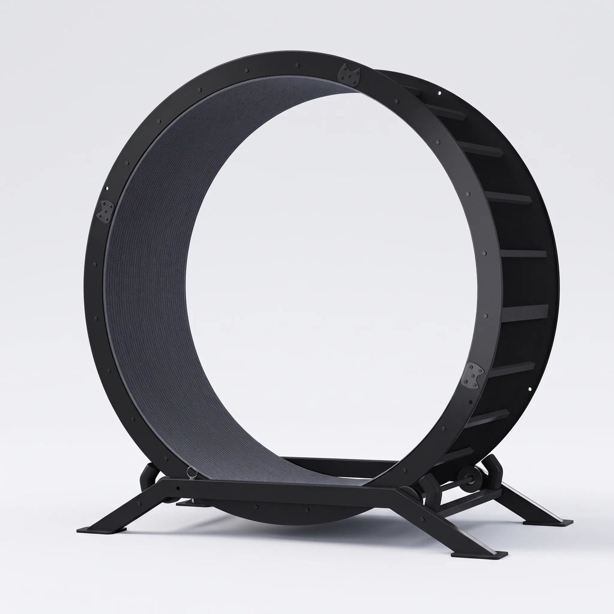 Roue d'exercice pour chat en acier noir posée sur un fond gris clair