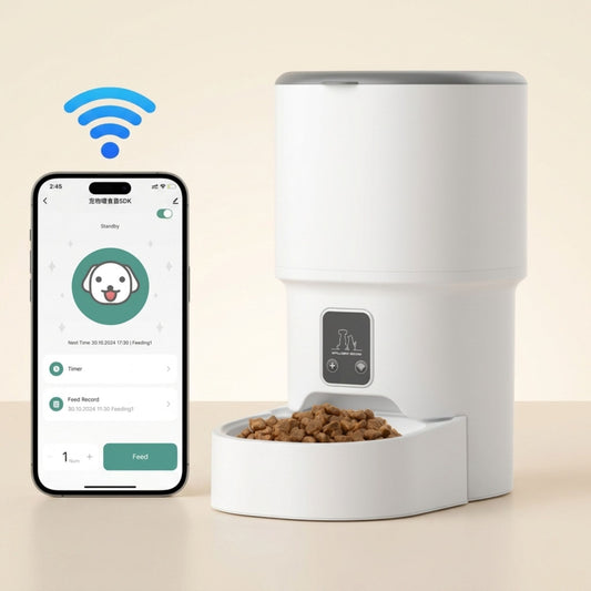 distributeur automatique de croquettes pour chat blanc connecté WiFi avec smartphone affichant l'application de contrôle à distance et bol rempli de croquettes, fond beige